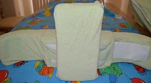 Back support pillow attached to the back panel vertically